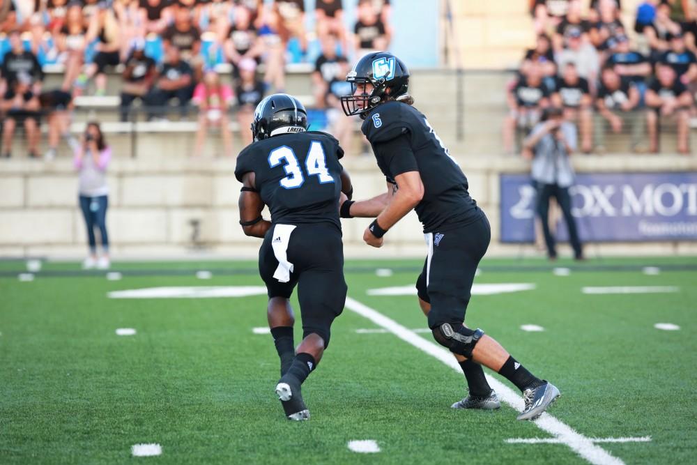 GVL / Kevin Sielaff 
Bart Williams (6) hands the ball off to Martayveous Carter (34). Grand Valley State squares off against Southwest Baptist Thursday, September 3rd, 2015 at Lubbers Stadium. 