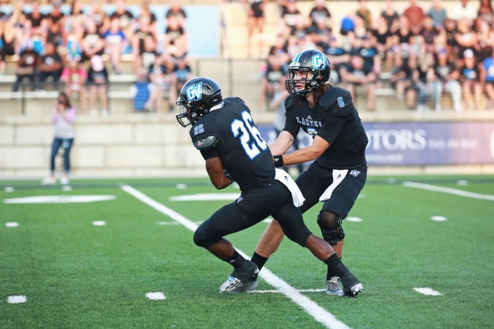 GVL / Kevin Sielaff 
Bart Williams (6) hands the ball of to Jalen Bryant (26). Grand Valley State squares off against Southwest Baptist Thursday, September 3rd, 2015 at Lubbers Stadium. 