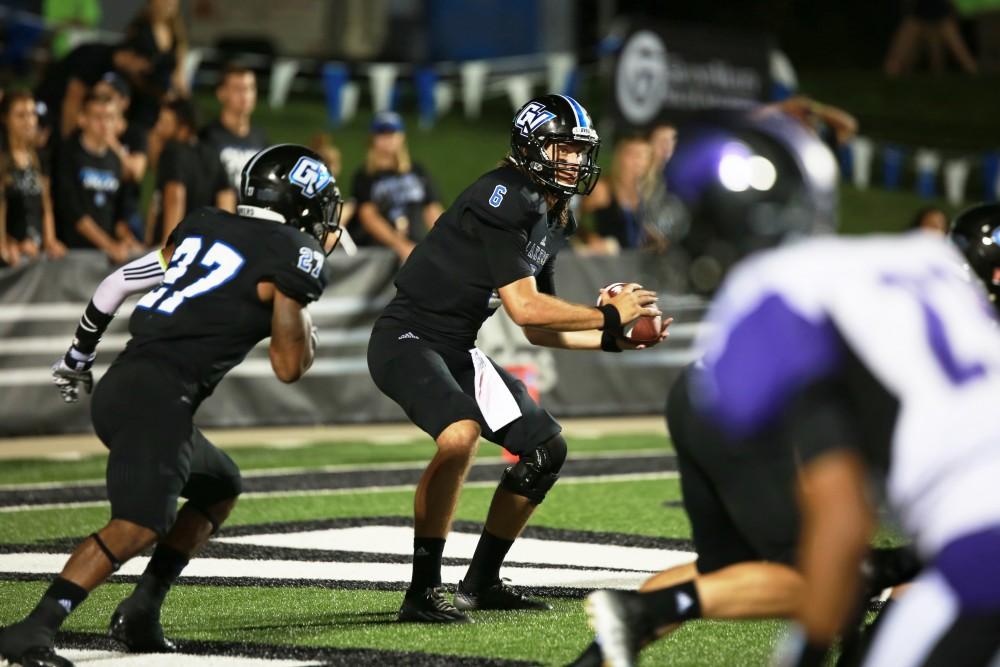 GVL / Kevin Sielaff 
Bart Williams (6) hands the ball off to Kirk Spencer (27). Grand Valley State squares off against Southwest Baptist Thursday, September 3rd, 2015 at Lubbers Stadium. 