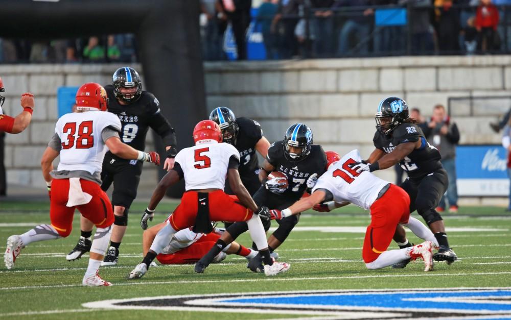 GVL / Kevin Sielaff     Kirk Spencer (27) attempts to split Ferris' defense. Grand Valley State University squares off against Ferris State University Sept. 19 at Lubbers Stadium in Allendale. The Lakers were defeated, with a final score of 61-24.