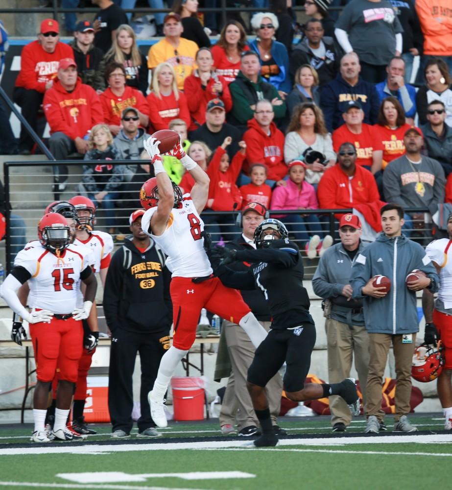 GVL / Kevin Sielaff     Alezay Coleman (8) is greeted by Devin McKissic (1) of Grand Valley.  Grand Valley State University squares off against Ferris State University Sept. 19 at Lubbers Stadium in Allendale. The Lakers were defeated, with a final score of 61-24.