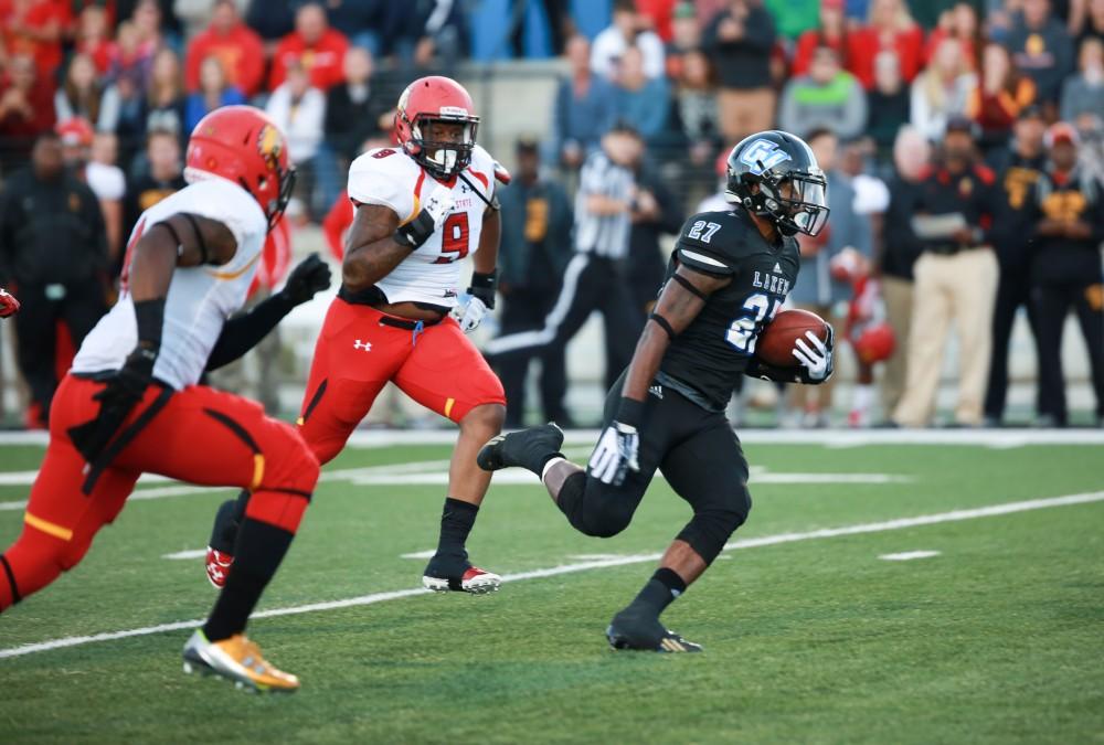 GVL / Kevin Sielaff     Kirk Spencer (27) slips through Ferris' defense. Grand Valley State University squares off against Ferris State University Sept. 19 at Lubbers Stadium in Allendale. The Lakers were defeated, with a final score of 61-24.