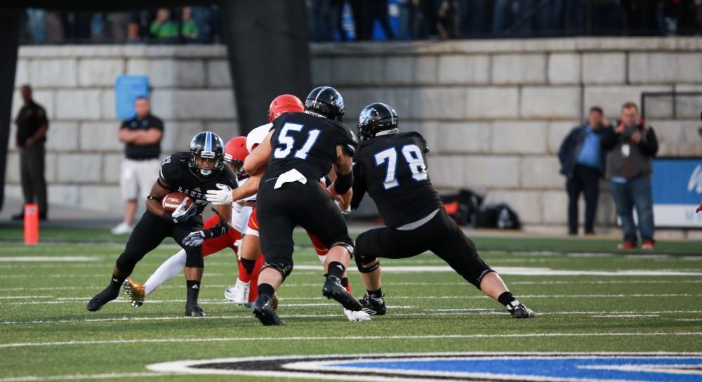 GVL / Kevin Sielaff     Kirk Spencer (27) attemps to find a gap in Ferris' defense line. Grand Valley State University squares off against Ferris State University Sept. 19 at Lubbers Stadium in Allendale. The Lakers were defeated, with a final score of 61-24.