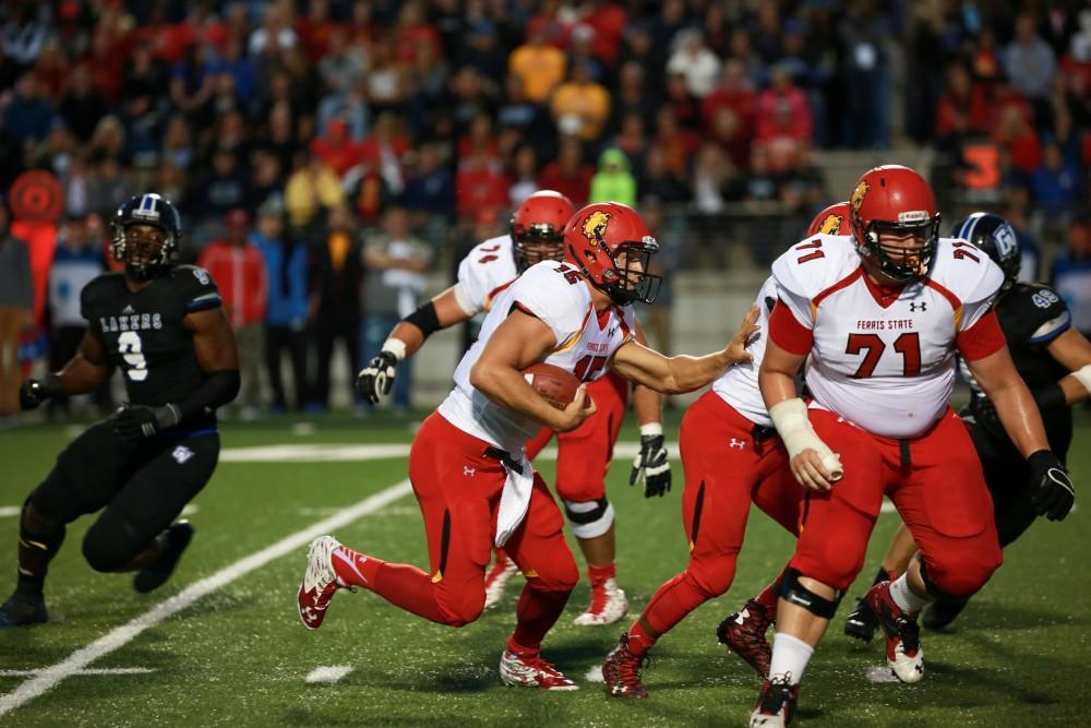 GVL / Kevin Sielaff    Ferris quarterback Jason Vander Laan (15) runs the ball toward the endzone. Grand Valley State University squares off against Ferris State University Sept. 19 at Lubbers Stadium in Allendale. The Lakers were defeated, with a final score of 61-24.