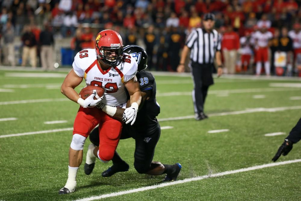 GVL / Kevin Sielaff     Ferris' Kyle Thompson (83) breaks a tackle from Grand Valley's Jeff Madison (39).  Grand Valley State University squares off against Ferris State University Sept. 19 at Lubbers Stadium in Allendale. The Lakers were defeated, with a final score of 61-24.