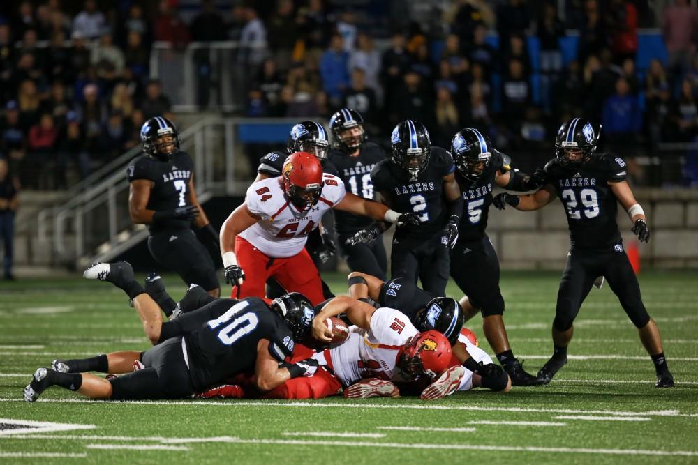 GVL / Kevin Sielaff     Ferris' quarterback Jason Vander Laan (15) is sacked. Grand Valley State University squares off against Ferris State University Sept. 19 at Lubbers Stadium in Allendale. The Lakers were defeated, with a final score of 61-24.