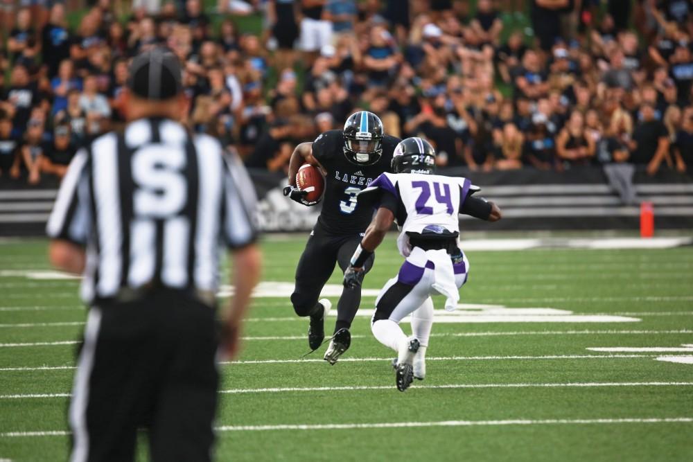 GVL / Kevin Sielaff 
Brandon Bean (3) angles his body to jump over the incoming defenseman. Grand Valley State squares off against Southwest Baptist Thursday, September 3rd, 2015 at Lubbers Stadium. 