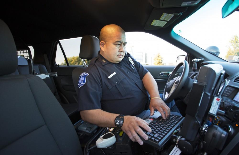 GVL/Kevin Sielaff
GVPD officer Minh Lien works within his patrol car Sept. 13 outside of Campus Life Night. 