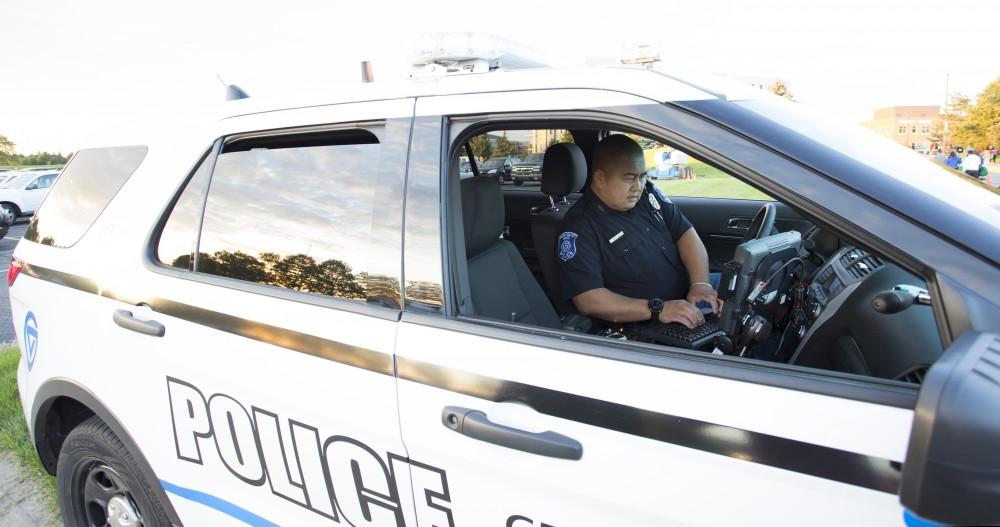 GVL/Kevin Sielaff
GVPD officer Minh Lien works within his patrol car Sept. 13 outside of Campus Life Night. 