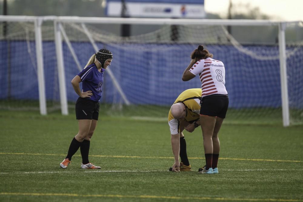 GVL / Sara Carte
Grand Valley’s Women’s Club Rugby captain, Maria Midena, converses with the referee before they go against Indiana University on Friday night, September 4th, 2015.