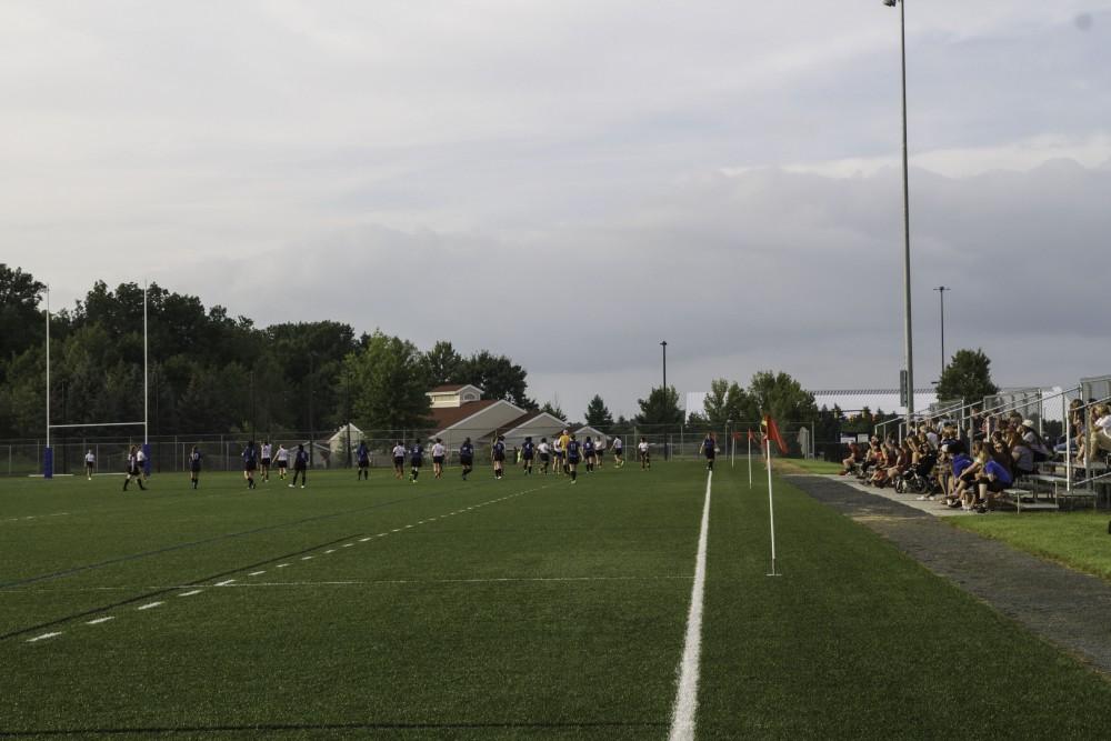 GVL / Sara Carte
Fans watch Grand Valley’s Women’s Club Rugby team go against Indiana University on Friday night, September 4, 2015.