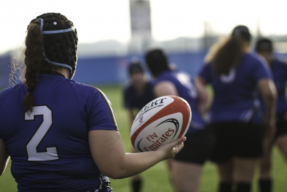 GVL / Sara Carte
Grand Valley’s Women’s Club Rugby player, DeAnna Hohn, throws the ball into her teammates against Indiana University on Friday night, September 4, 2015.