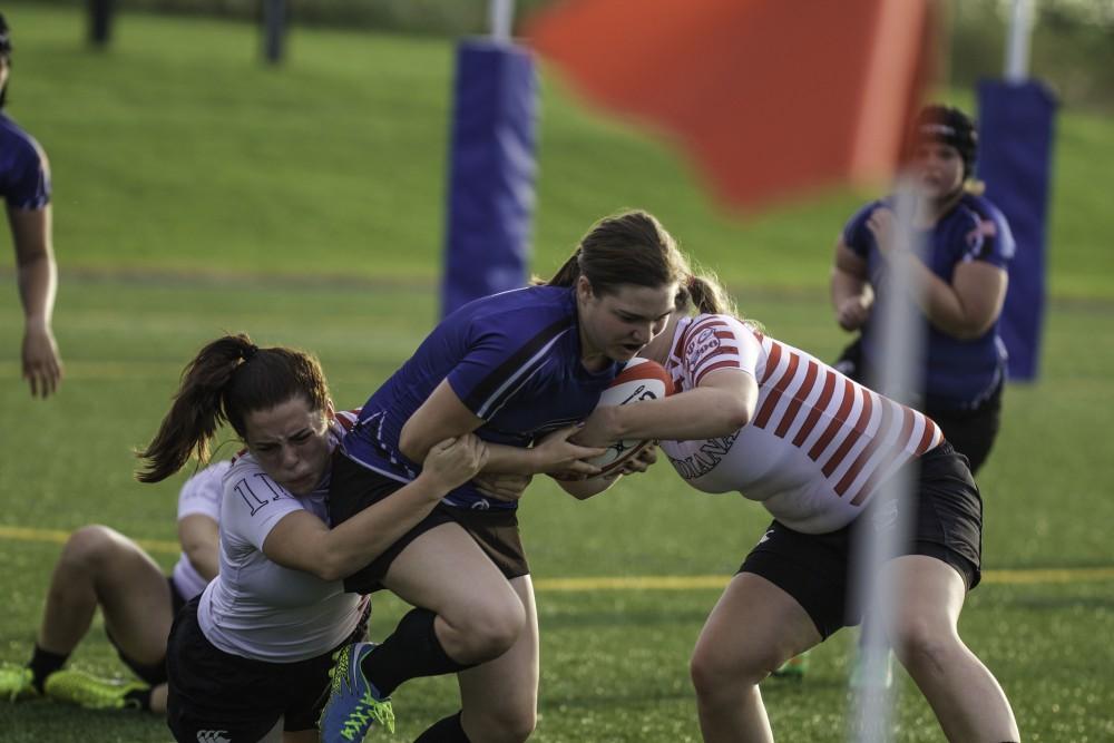 GVL / Sara Carte
Grand Valley’s Women’s Club Rugby player, Skylar Thompson, runs the ball against Indiana University on Friday night, September 4, 2015.