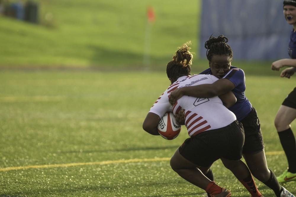 GVL / Sara Carte
Grand Valley’s Women’s Club Rugby player, Chandler Babb, tackles an Indiana university player on Friday night, September 4, 2015.