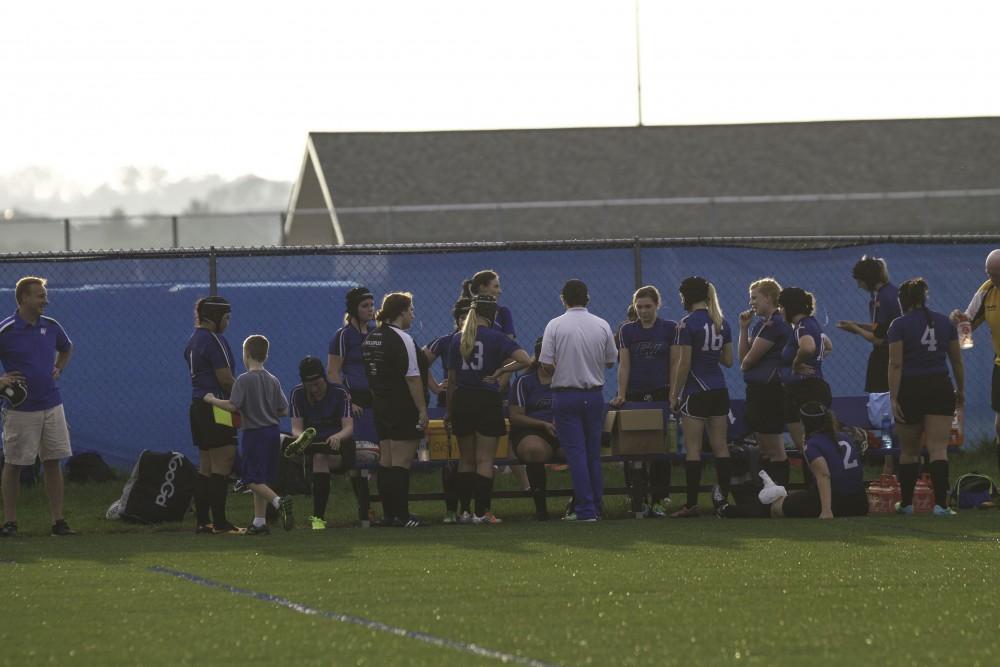 GVL / Sara Carte
GRand Valley’s Women’s Club Rugby coach, Abe Cohen, collaborates with his team during half time against Indiana Universtiy on Friday night, September 4, 2015.