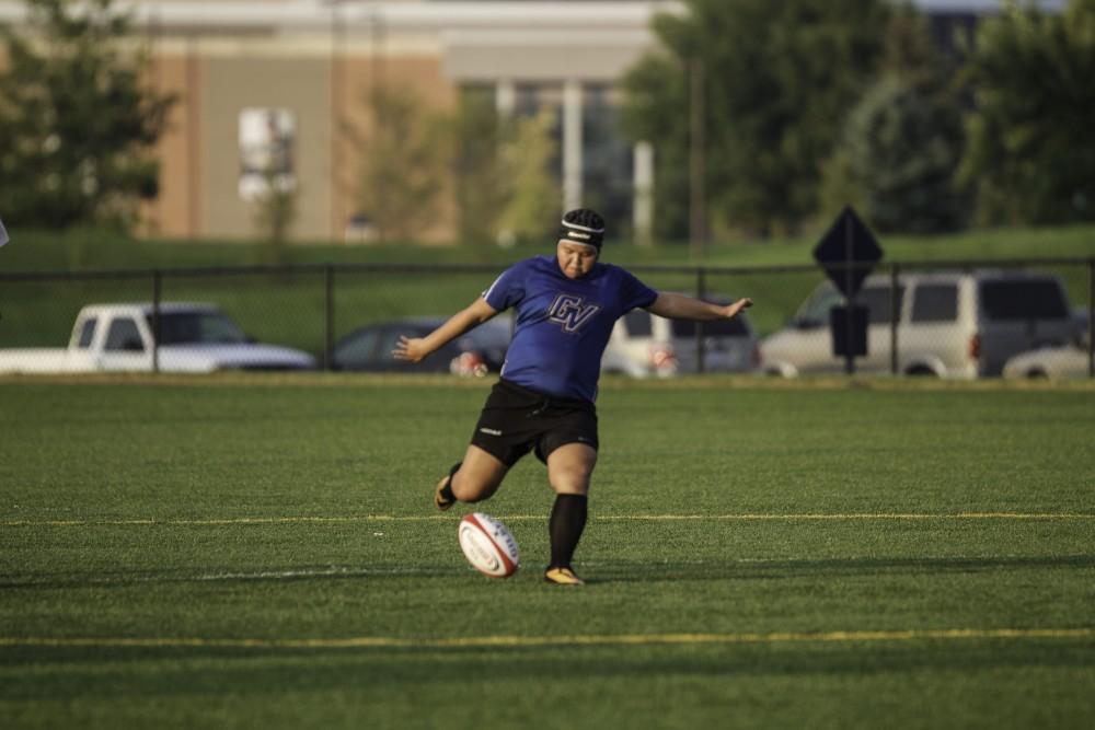 GVL / Sara Carte
Grand Valley’s Women’s Club Rugby player, Leah Fast, kicks the ball towards her teammates against indiana university on Friday night, September 4, 2015.