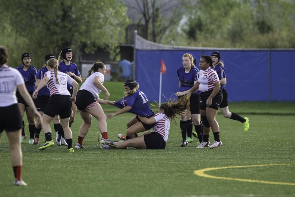 GVL / Sara Carte
Grand Valley’s Women’s Rugby captain, Maria Midena, gets tackled by Indiana University on Friday night, September 4, 2105.