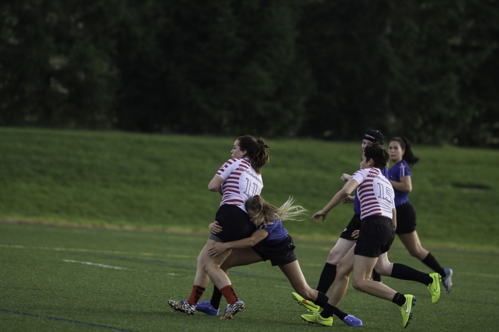 GVL / Sara Carte
Grand Valley’s Women’s Club Rugby player, Mackenzie Moore, tackles an Indiana University player on Friday night, September 4, 2015.