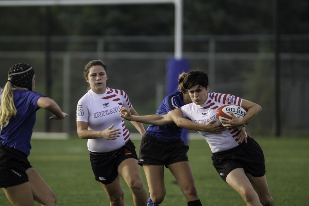 GVL / Sara Carte
Grand Valley’s Women’s Club Rugby player, Mackenzie Moore, tackles an Indiana University player on Friday night, Septemeber 4, 2015.