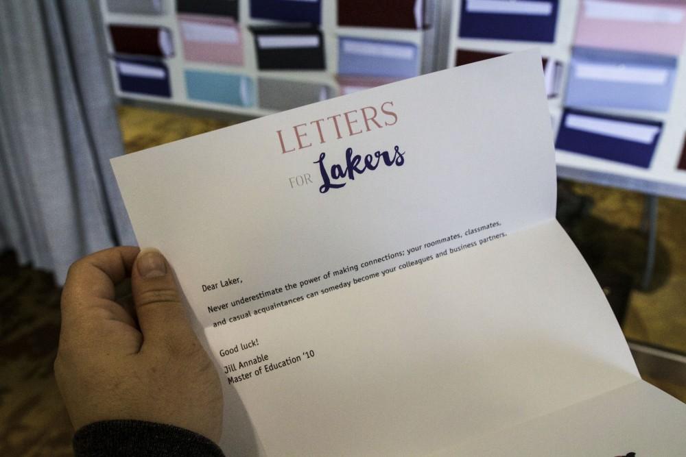 GVL / Sara Carte
Grand Valley graduates and upperclassmen share a letter of advice in the envelopes of the Letters to Lakers sticky note exhibit, located on the Atrium level of the Mary Idema Pew Library on Thursday, September 10, 2015.