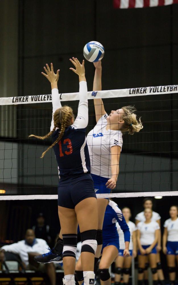 GVL / Kevin Sielaff     Jessica Majerle (3) hits the ball over the net. The Laker Vollyeball team squares off against SVSU Sept. 19 inside the Fieldhouse Arena in Allendale. The Lakers defeated SVSU by a margin of 3-1.