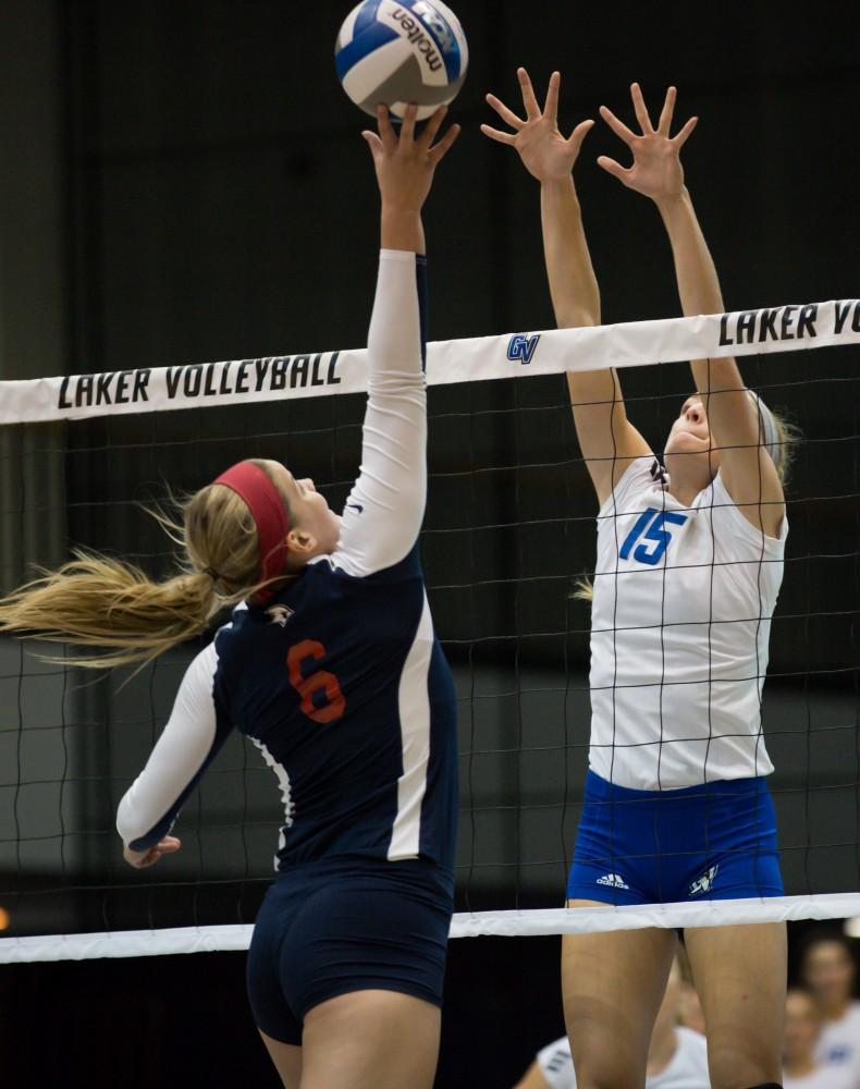 GVL / Kevin Sielaff     Kaleigh Lound (15) goes up for a block. The Laker Vollyeball team squares off against SVSU Sept. 19 inside the Fieldhouse Arena in Allendale. The Lakers defeated SVSU by a margin of 3-1.