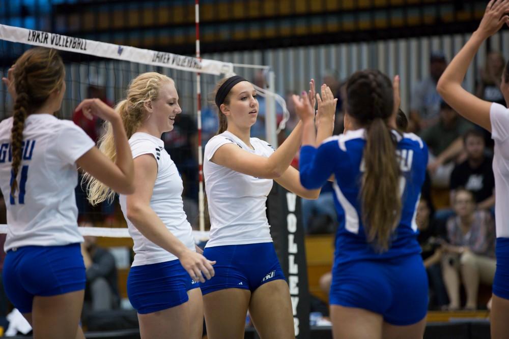 GVL / Kevin Sielaff     Jillian Butsavich (12) celebrates wih her team. The Laker Vollyeball team squares off against SVSU Sept. 19 inside the Fieldhouse Arena in Allendale. The Lakers defeated SVSU by a margin of 3-1.