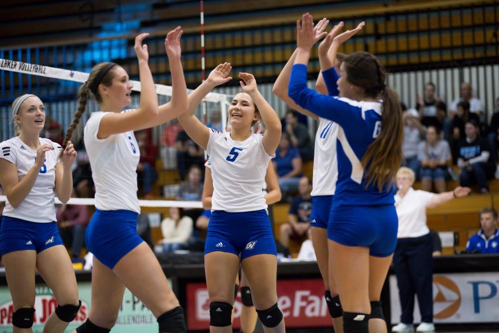 GVL / Kevin Sielaff     Taylor Stewart (5) high-fives her teammates. The Laker Vollyeball team squares off against SVSU Sept. 19 inside the Fieldhouse Arena in Allendale. The Lakers defeated SVSU by a margin of 3-1.