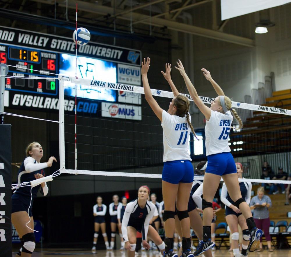 GVL / Kevin Sielaff     Kourtney Wolters (11) and Kaleigh Lound (15) attempt a block. The Laker Vollyeball team squares off against SVSU Sept. 19 inside the Fieldhouse Arena in Allendale. The Lakers defeated SVSU by a margin of 3-1.