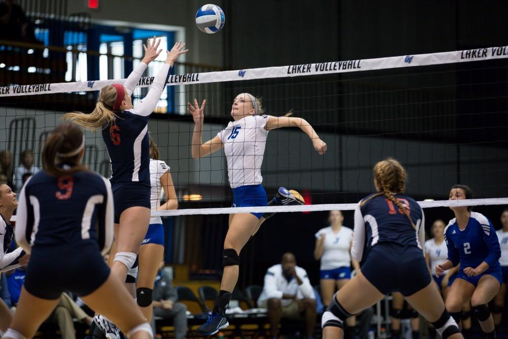 GVL / Kevin Sielaff     Kaleigh Lound (15) attempts to tip the ball over SVSU's defense. The Laker Vollyeball team squares off against SVSU Sept. 19 inside the Fieldhouse Arena in Allendale. The Lakers defeated SVSU by a margin of 3-1.