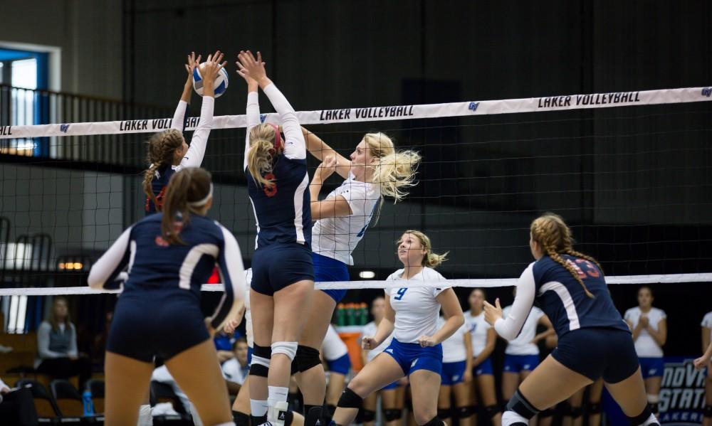 GVL / Kevin Sielaff     Staci Brower (21) is greeted by two SVSU defenders. The Laker Vollyeball team squares off against SVSU Sept. 19 inside the Fieldhouse Arena in Allendale. The Lakers defeated SVSU by a margin of 3-1.