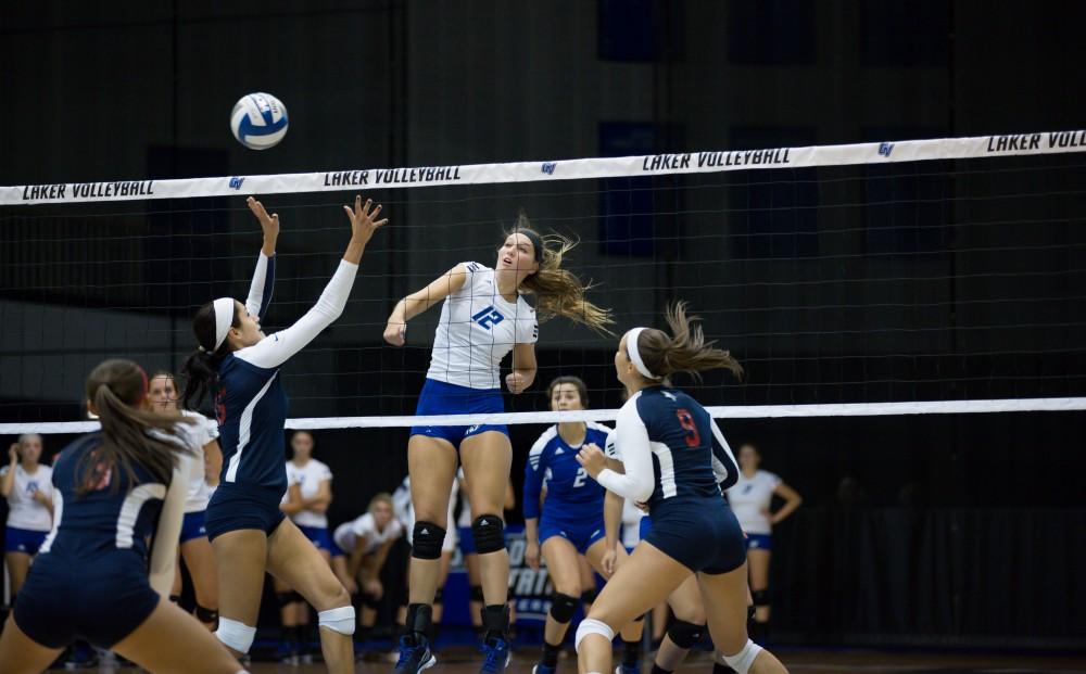 GVL / Kevin Sielaff     Jillian Butsavich (12) spikes the ball over the net. The Laker Vollyeball team squares off against SVSU Sept. 19 inside the Fieldhouse Arena in Allendale. The Lakers defeated SVSU by a margin of 3-1.