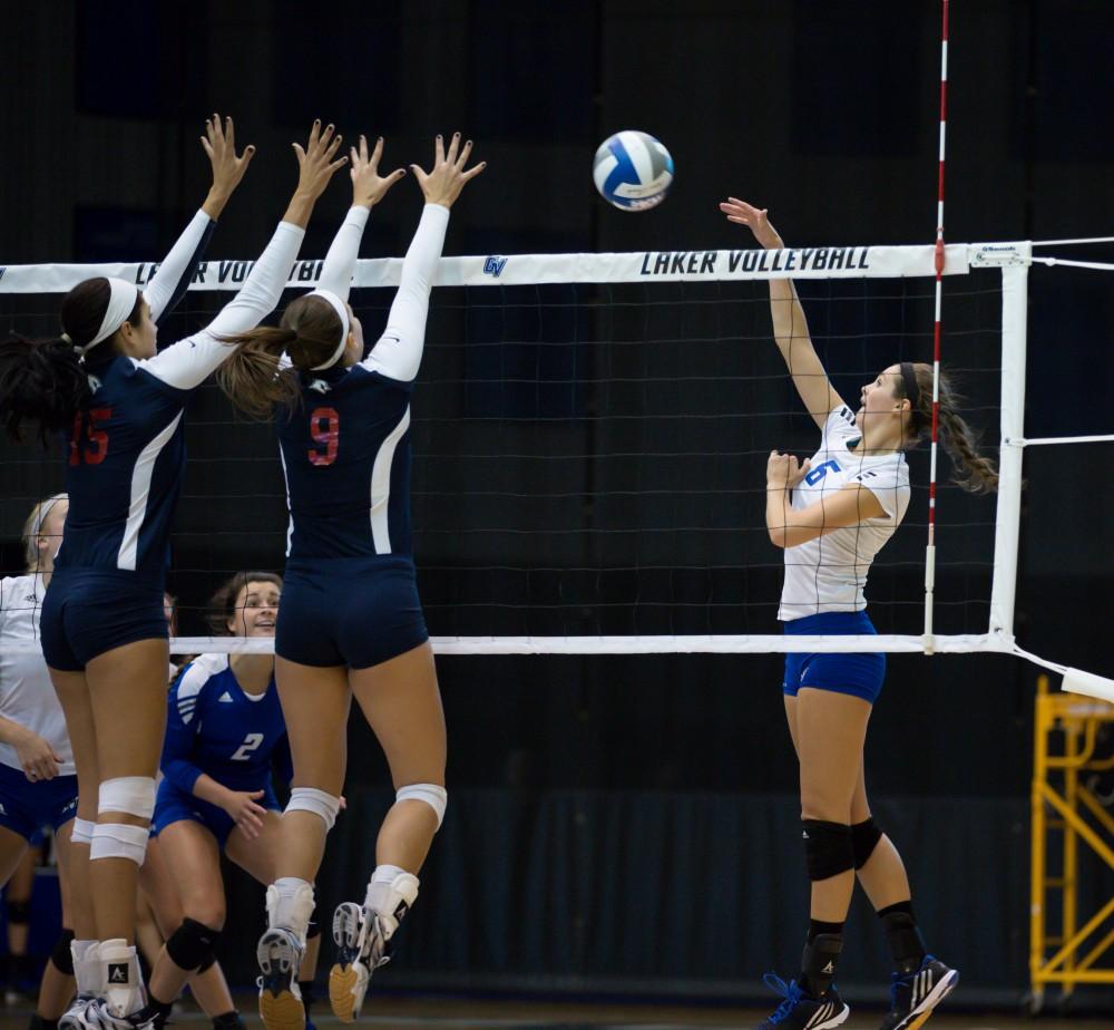 GVL / Kevin Sielaff     Betsy Rhonda (6) tips the ball over the net. The Laker Vollyeball team squares off against SVSU Sept. 19 inside the Fieldhouse Arena in Allendale. The Lakers defeated SVSU by a margin of 3-1.