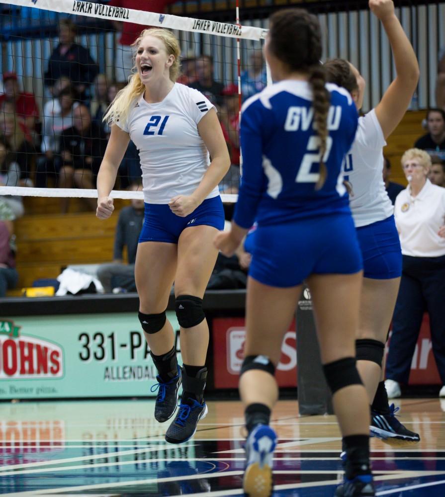 GVL / Kevin Sielaff     Staci Brower (21) jumps for joy after a point scored. The Laker Vollyeball team squares off against SVSU Sept. 19 inside the Fieldhouse Arena in Allendale. The Lakers defeated SVSU by a margin of 3-1.