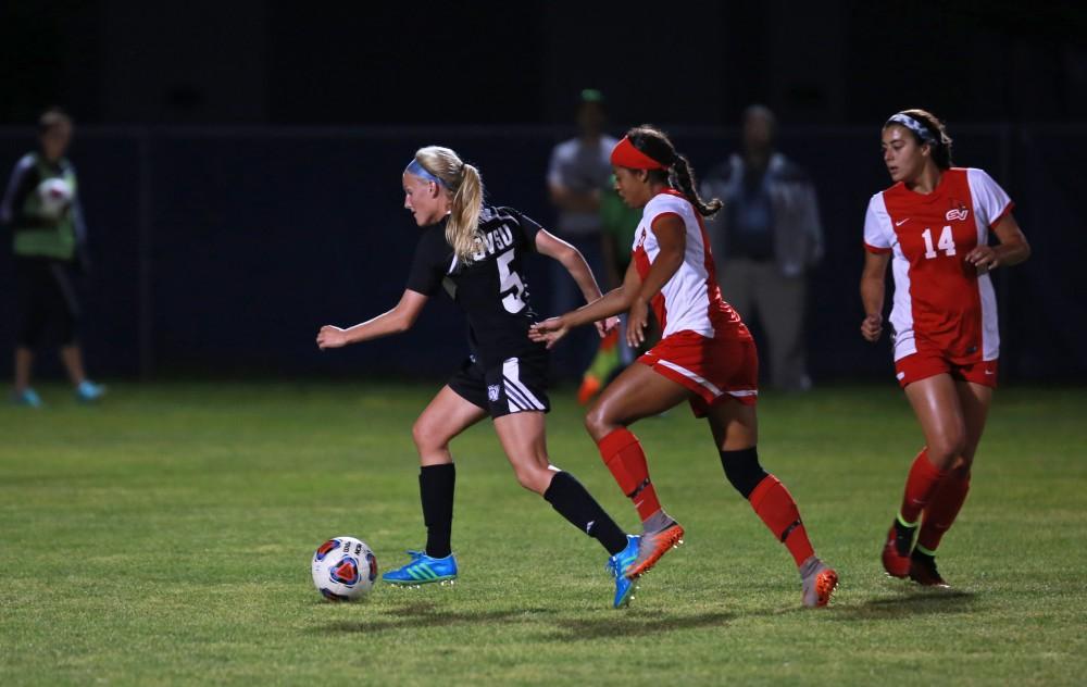 GVL/Kevin Sielaff  
Kendra Stauffer (5) dribbes the ball back toward the GV defense. The Laker soccer team defeats SVSU Sept. 22 by a margin of 6-1 in Allendale.  