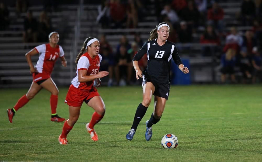 GVL/Kevin Sielaff  
Marti Corby (13) dribbles the ball around midfield. The Laker soccer team defeats SVSU Sept. 22 by a margin of 6-1 in Allendale.  