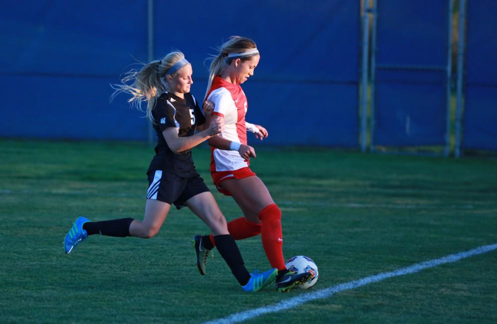 GVL/Kevin Sielaff  
Kendra Stauffer (5) attempts to push Ashley Henderson (5) of SVSU out of bounds. The Laker soccer team defeats SVSU Sept. 22 by a margin of 6-1 in Allendale.  