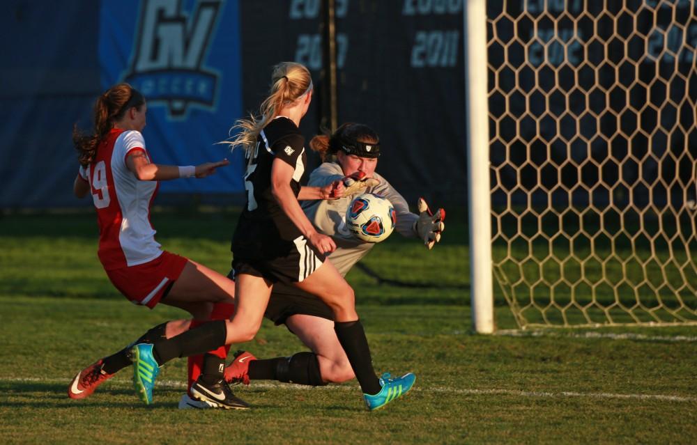 GVL/Kevin Sielaff  
Kendra Stauffer (5) attempts a shot against goalkeeper Claire Spleth (0). The Laker soccer team defeats SVSU Sept. 22 by a margin of 6-1 in Allendale.  