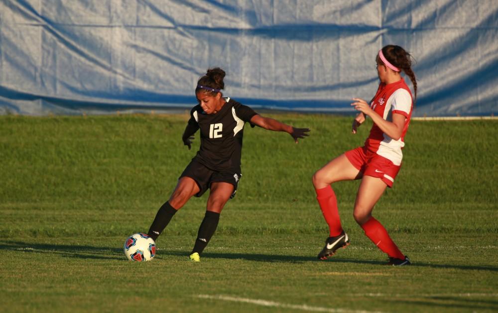 GVL/Kevin Sielaff  
Jayma Martin (12) crosses the ball. The Laker soccer team defeats SVSU Sept. 22 by a margin of 6-1 in Allendale.  