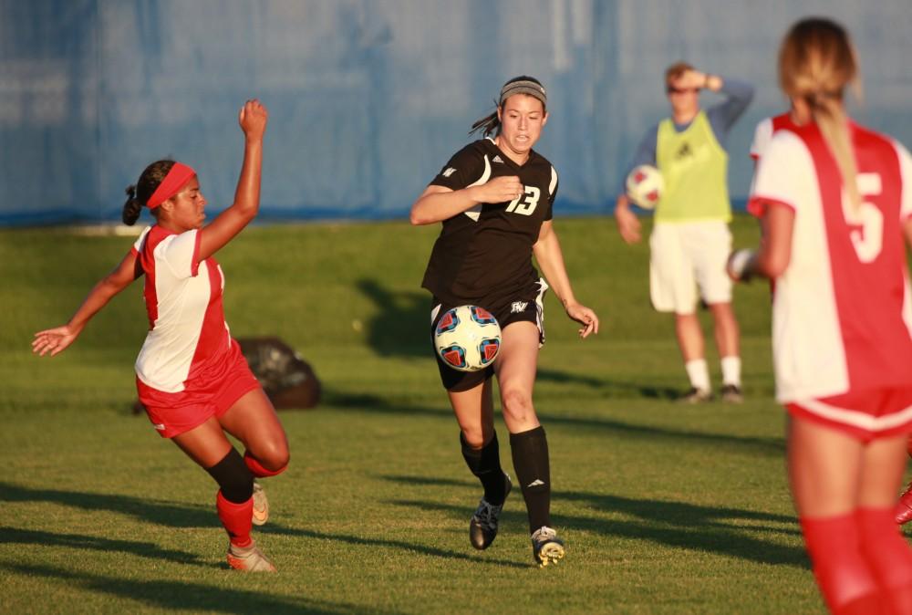 GVL/Kevin Sielaff  
Marti Corby (13) moves the ball against Bria Spraggins (4). The Laker soccer team defeats SVSU Sept. 22 by a margin of 6-1 in Allendale.  