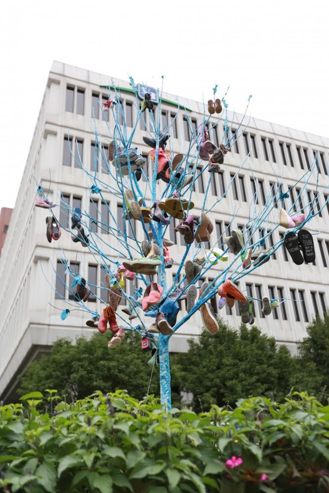 GVL / Kevin Sielaff  
Janelle Dahlberg's piece entitled "Phenomena 117" consists of shoes hanging on a tree which have statements or wishes written on the soles. Grand Rapids' annual ArtPrize is held from Sept. 23 - Oct. 1 at various locations around the city. 