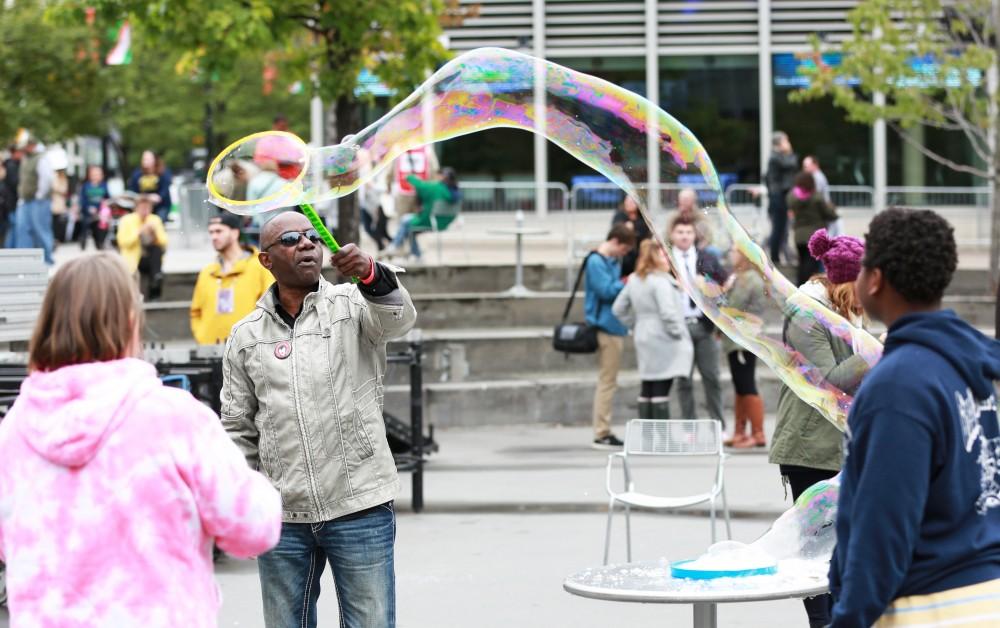 GVL / Kevin Sielaff  
David Adams waves a bubble wand in Rose Parks Circle. Grand Rapids' annual ArtPrize is held from Sept. 23 - Oct. 1 at various locations around the city. 