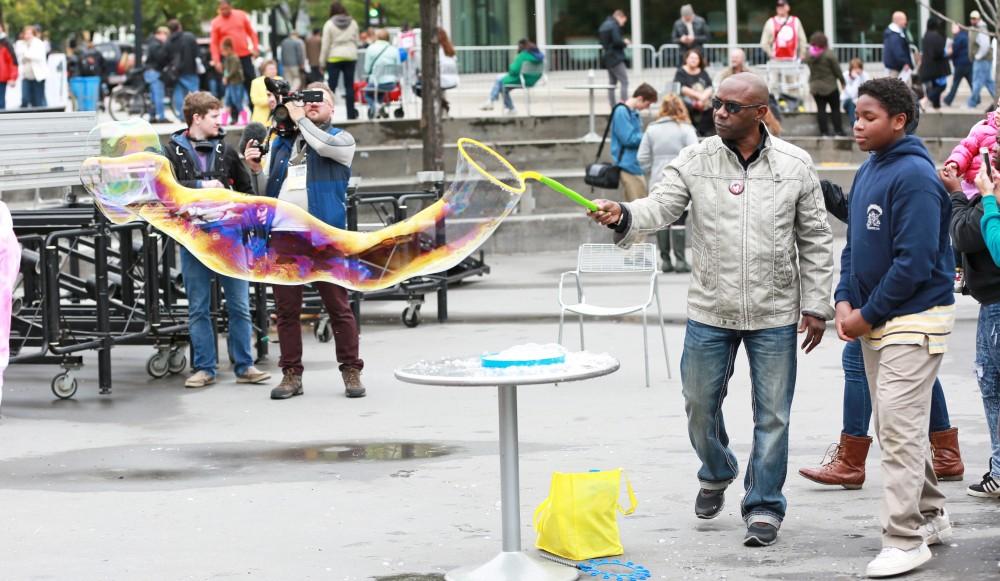 GVL / Kevin Sielaff  
David Adams waves a bubble wand in Rose Parks Circle. Grand Rapids' annual ArtPrize is held from Sept. 23 - Oct. 1 at various locations around the city. 