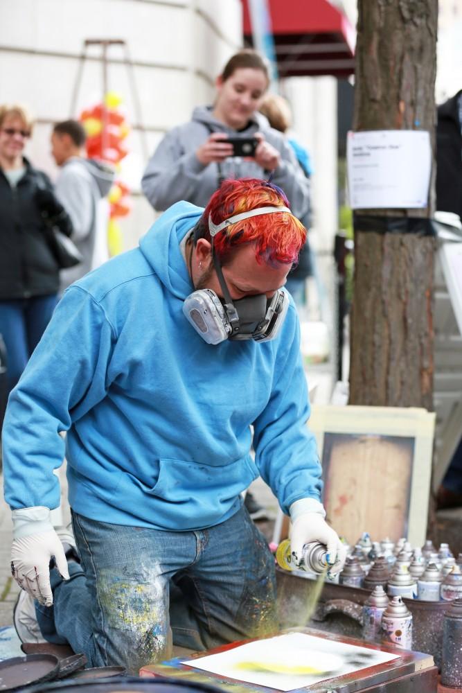 GVL / Kevin Sielaff  
Andy Watkins creates spray paint art in record time to be sold or viewed. Grand Rapids' annual ArtPrize is held from Sept. 23 - Oct. 1 at various locations around the city. 