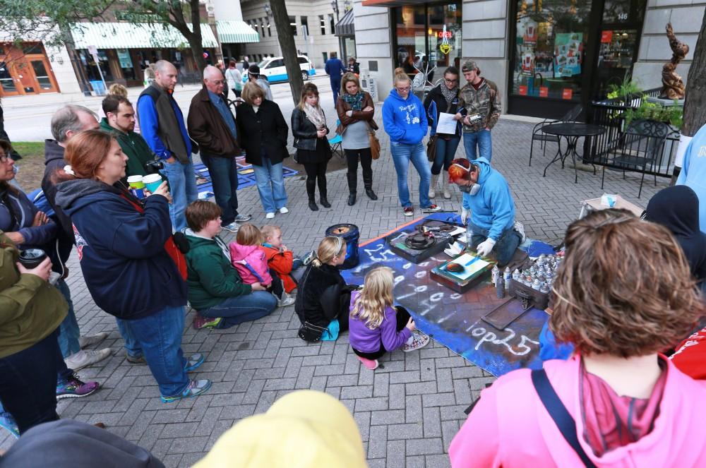 GVL / Kevin Sielaff  
Andy Watkins creates spray paint art in record time to be sold or viewed. Grand Rapids' annual ArtPrize is held from Sept. 23 - Oct. 1 at various locations around the city. 