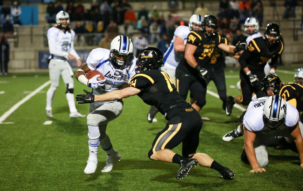 GVL / Kevin Sielaff - Kirk Spencer (27) jukes toward the end zone.  Grand Valley squares off against Michigan Tech Oct. 17 at Lubbers Stadium in Allendale. The Lakers defeated the Huskies with a score of 38-21.