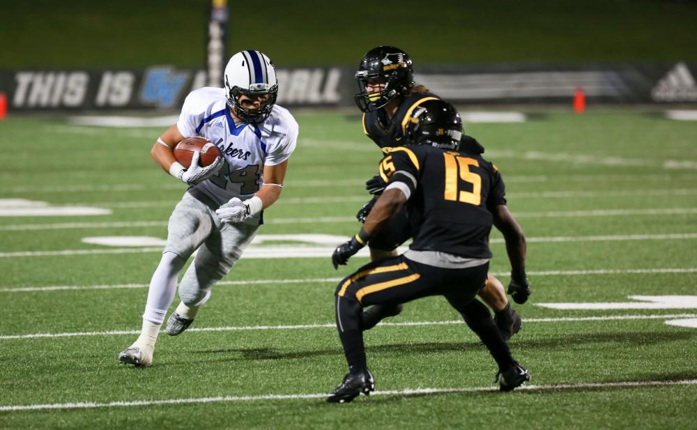 GVL / Kevin Sielaff - Matt Williams (24) prepares to break a tackle. Grand Valley squares off against Michigan Tech Oct. 17 at Lubbers Stadium in Allendale. The Lakers defeated the Huskies with a score of 38-21.