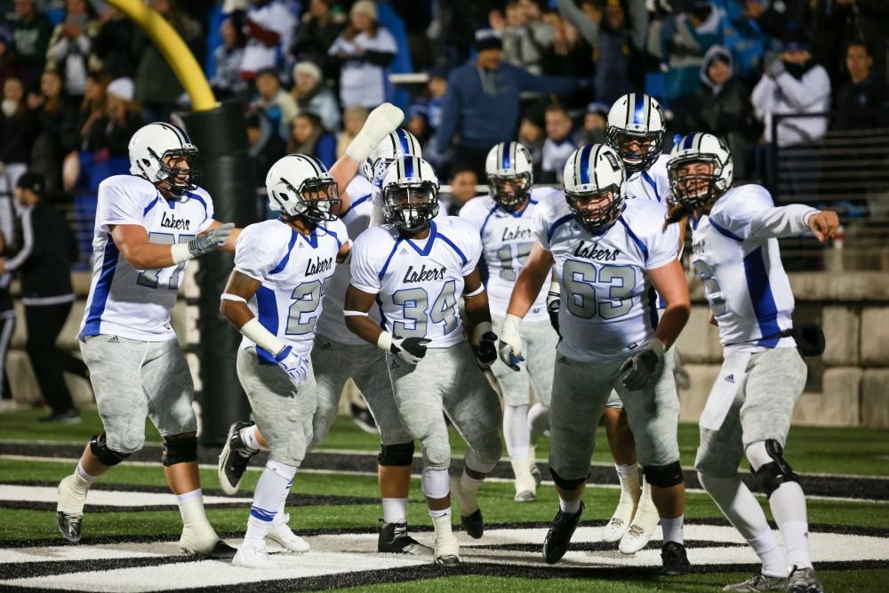 GVL / Kevin Sielaff - The Lakers celebrate with Marty Carter (34) as they take control of the game.  Grand Valley squares off against Michigan Tech Oct. 17 at Lubbers Stadium in Allendale. The Lakers defeated the Huskies with a score of 38-21.