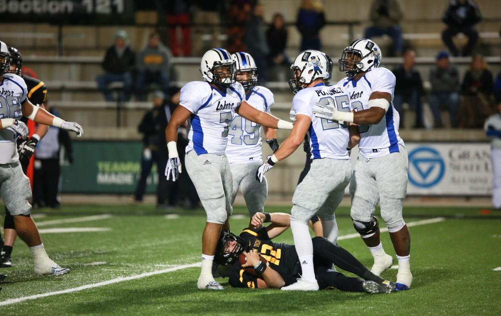 GVL / Kevin Sielaff - The Lakers collectively sack Michigan Tech's Brandon Cowie (12).  Grand Valley squares off against Michigan Tech Oct. 17 at Lubbers Stadium in Allendale. The Lakers defeated the Huskies with a score of 38-21.