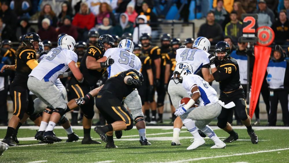 GVL / Kevin Sielaff -  Kirk Spencer (27) jukes into Michigan Tech's defensive line. Grand Valley squares off against Michigan Tech Oct. 17 at Lubbers Stadium in Allendale. The Lakers defeated the Huskies with a score of 38-21.